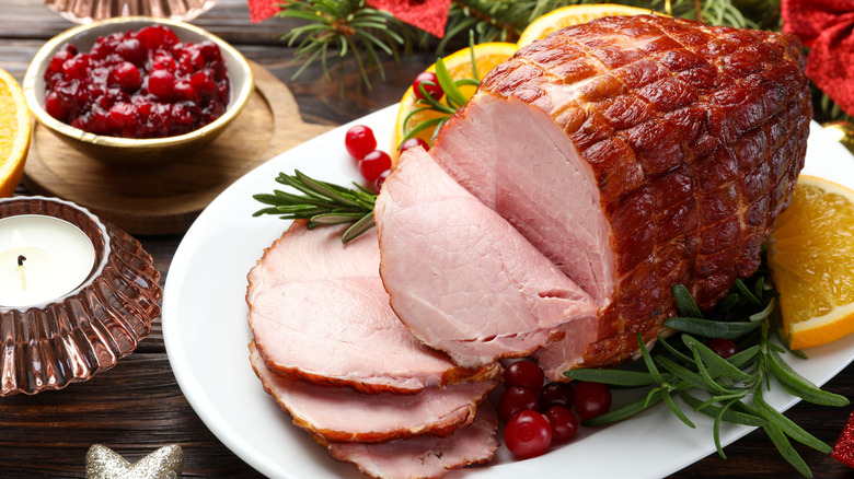 A baked ham, served with cranberry sauce