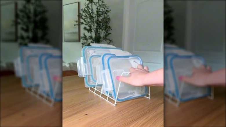 Wire dish drying racks being used to store plastic lids
