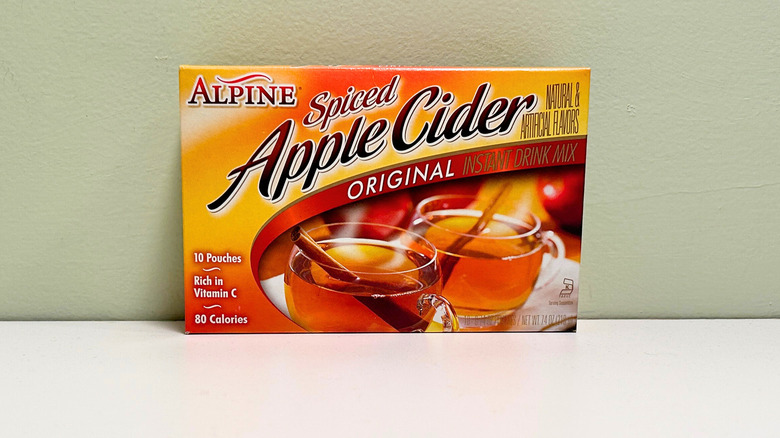 A box of spiced apple cider against a green and white background