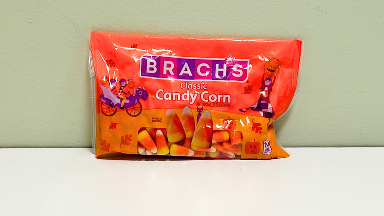 A bag of candy corn against a green and white background