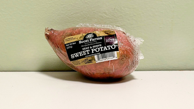 A sweet potato against a green and white background