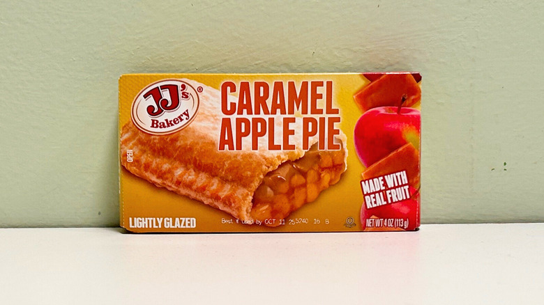 A boxed caramel apple pie against a green and white background