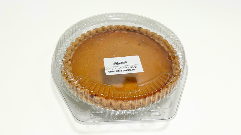 A pumpkin pie against a white background