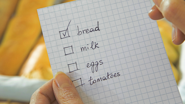 A person checking items off a shopping list