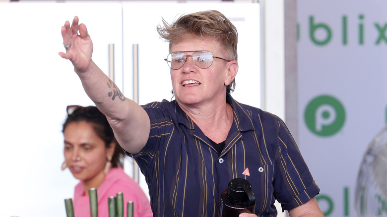 Crista Luedtke holds her hand up during a cooking competition sponsored by Publix