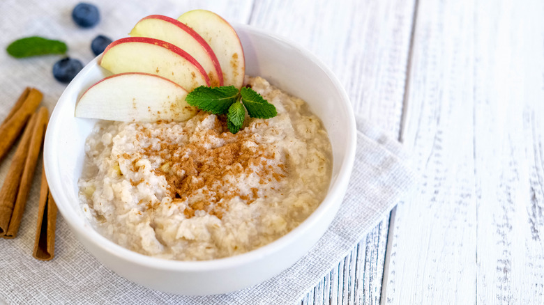 bowl of oatmeal with apple slices