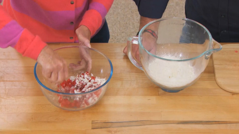 Mary Berry demonstrates coating cherries in flour to add to a cake