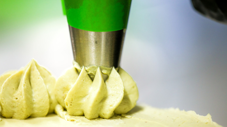 A piping bag used for decorating a cake with icing