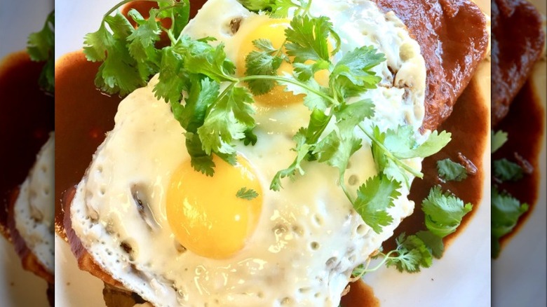 Enchiladas with 2 eggs on top