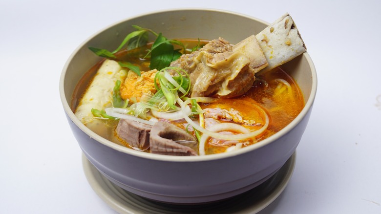 A bowl of bun bo Hue on a white background