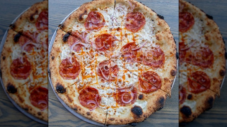 Charred pizza with capicola, onion, and honey