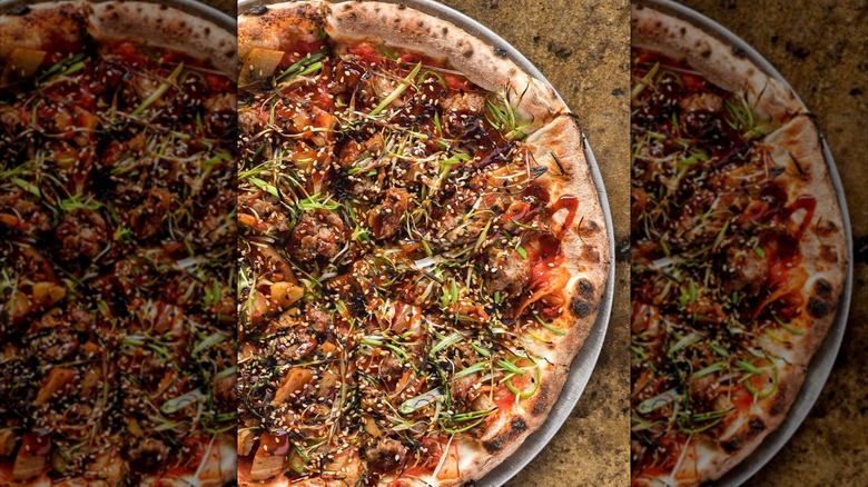 Pizza with kimchi and fresh scallions