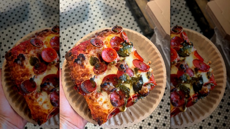 Close up of pizza with sausage, pepperoni, and jalepenos