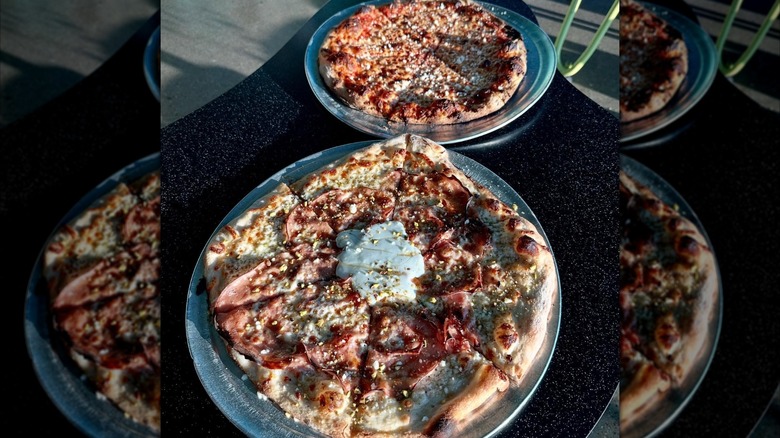 Pizza with mortadella, stracciatella cheese, and a drizzle of honey