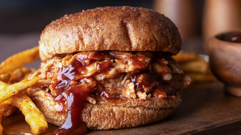 A barbecue pulled chicken sandwich in a wholegrain bun