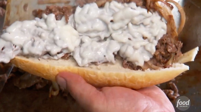 Steak and cheese are piled into a roll at Sonny's Famous Steak Hogies