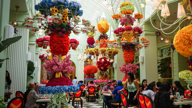 A large, fancy atrium dining room at Wynn Casino Vegas with ornate festive decorations