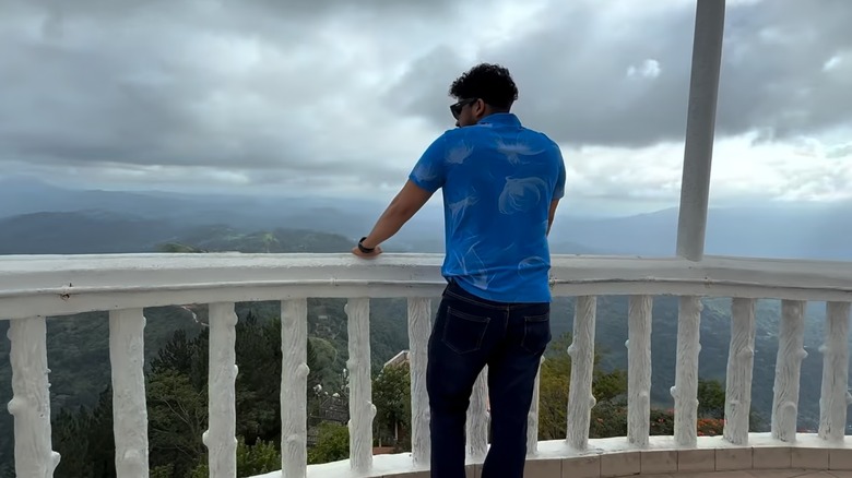 Cherith N Silva, the creator of the YouTube channel Wild Cookbook, stands looking out over a valley, in a still from one of his videos