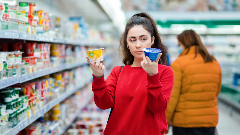 woman comparing yogurt
