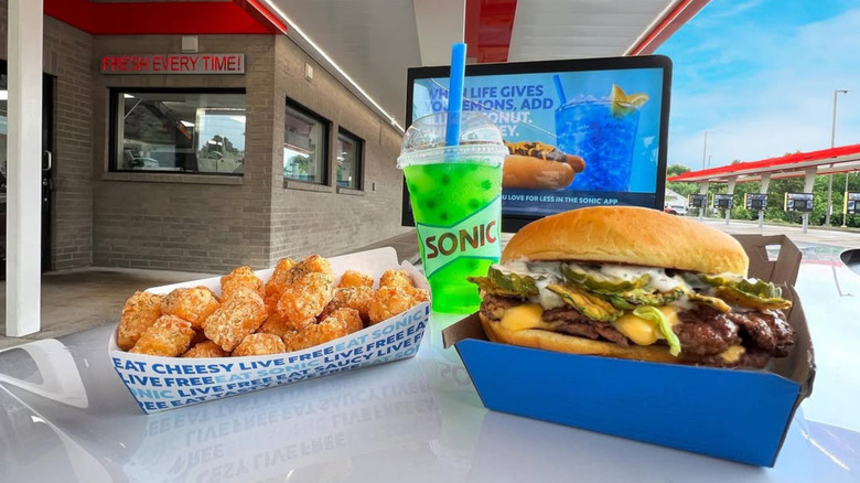 sonic x grillo's big dill meal on a table outside of sonic drive-in