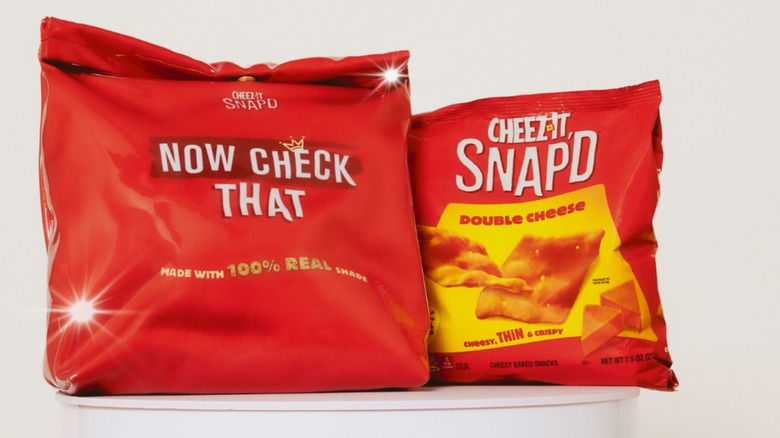 a bag of cheez-it snap'd chips next to a red handbag that looks like the chip bag, against a white background
