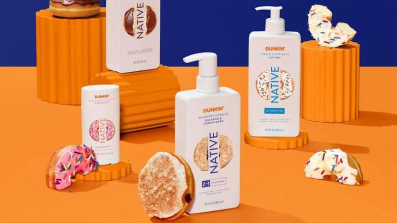 styled shot of native x dunkin bodycare products styled with donuts against a blue and orange background