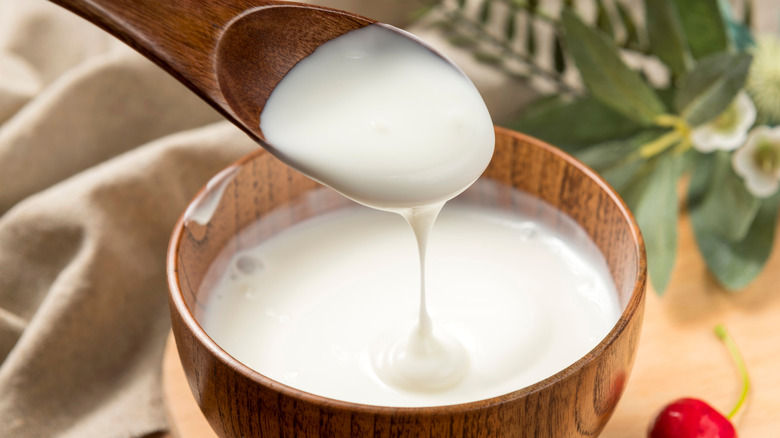 Yogurt being spooned out of bowl