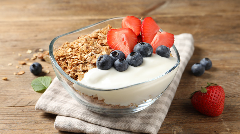 A small bowl of yogurt with granola and fresh fruit