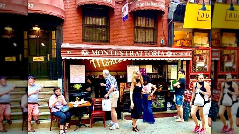 The exterior of Monte's Trattoria, with multiple people outside