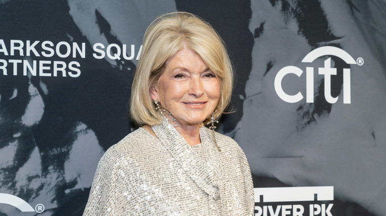 Martha Stewart poses in front of a board for a Citi-sponsored event