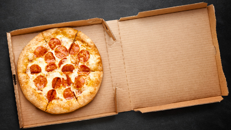 A takeout pizza in a cardboard box
