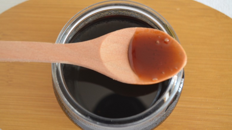 A jar and spoonful of molasses