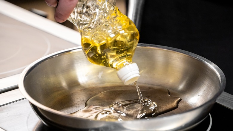 Cooking oil is poured into a pan