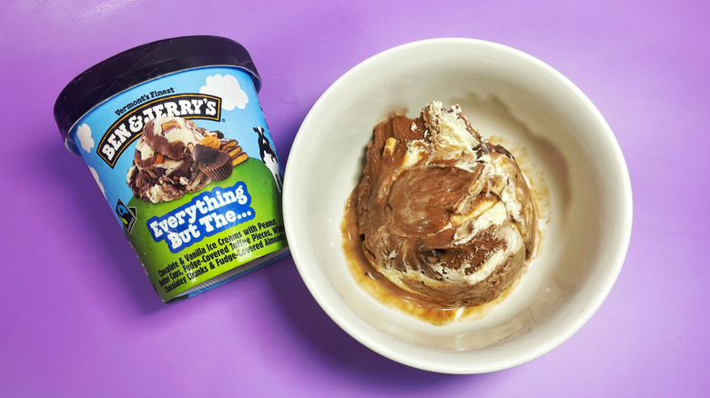 A scoop of Everything But The... in a bowl next to its container
