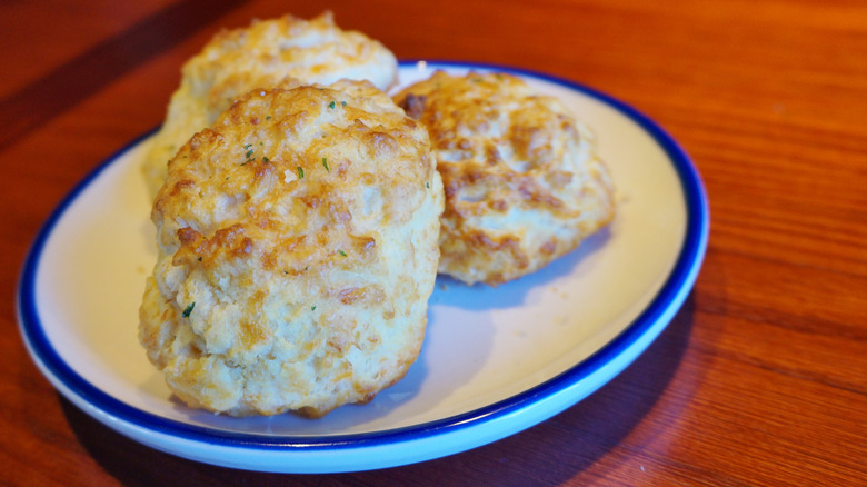 A plate full of cheddar bay biscuits from Red Lobster on a wooden table