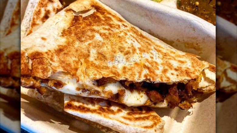 Two pieces of Chipotle quesadillas in a white container