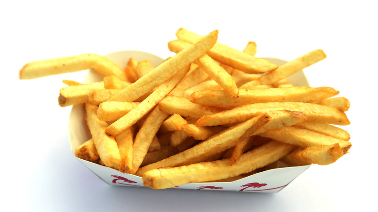 French fries from In-N-Out in a white container placed on a white table