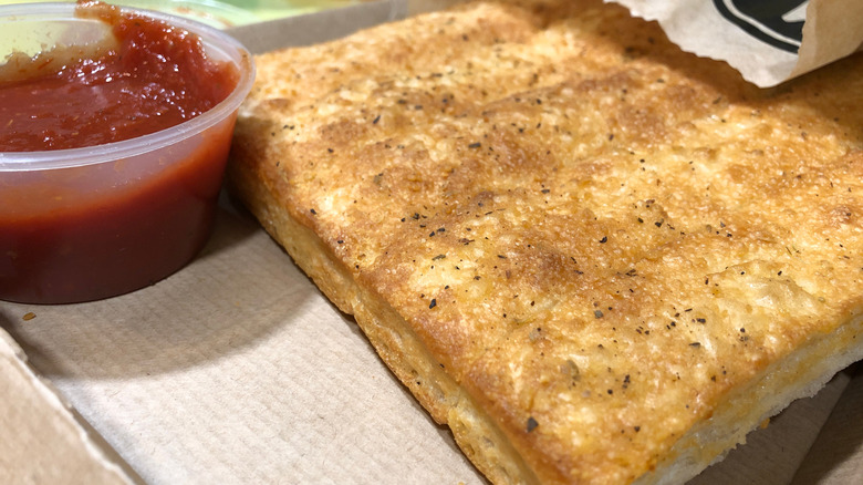 Breadsticks from Pizza Hut with a bowl on marinara sauce on the side