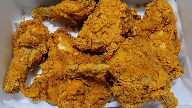 A close-up of Publix fried chicken in a paper container