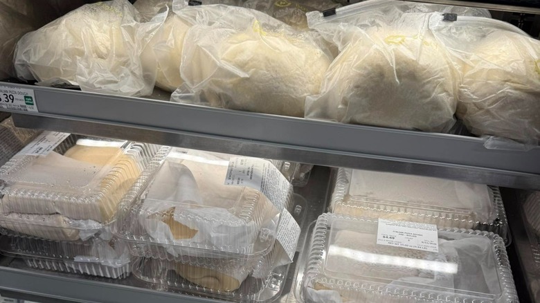 Wrapped balls of pre-made pizza dough on a Publix deli shelf