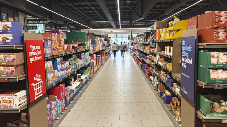 interior shot of Aldi aisle, shelves, customers in distance