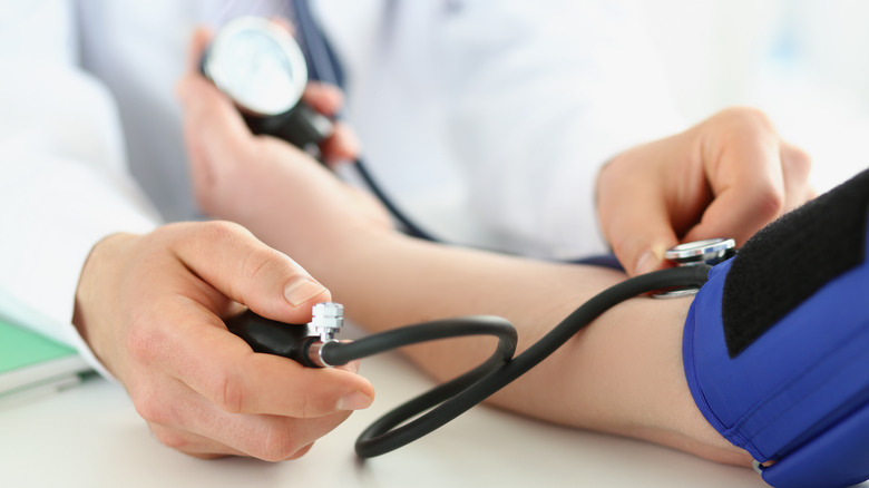 Person measuring blood pressure