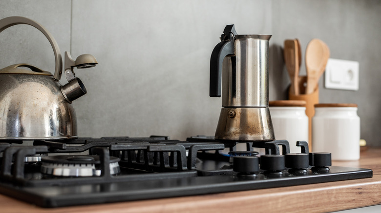 Kettle and percolator on modern kitchen stovetop