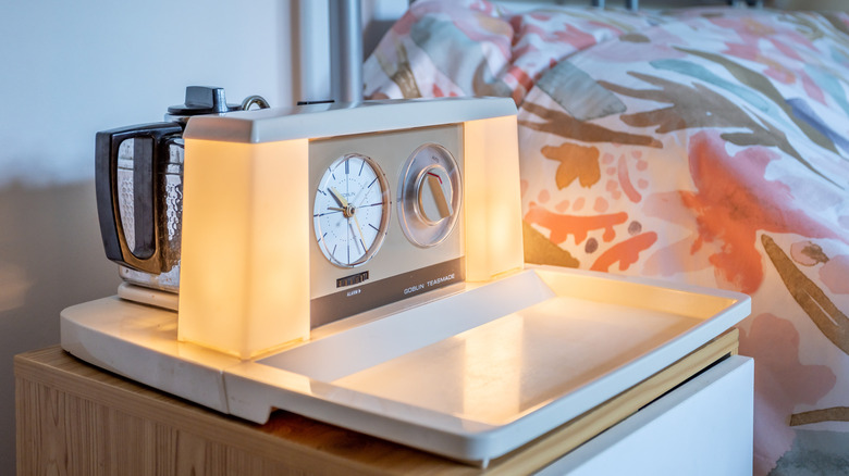 Vintage Teasmade machine illuminated on bedside table