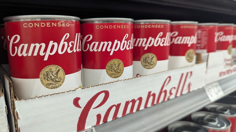 Cans of Campbell's soup on a supermarket shelf