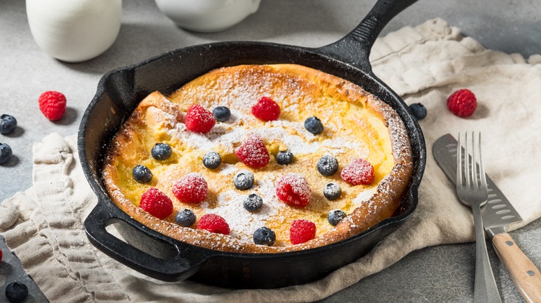 A Dutch baby pancake with berries and powdered sugar