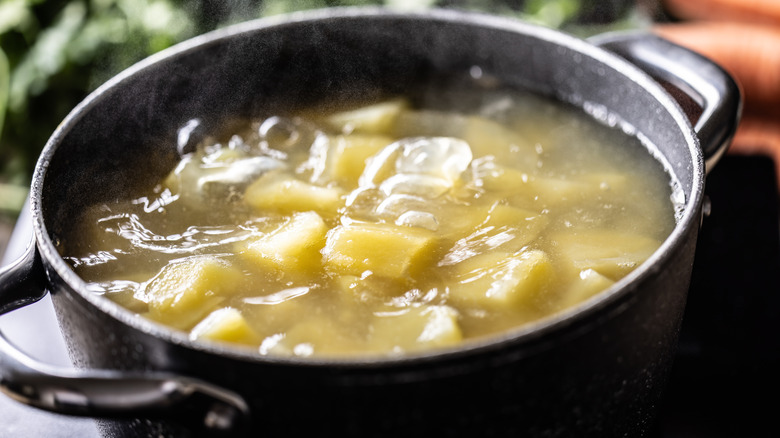 Potatoes boiling in pot
