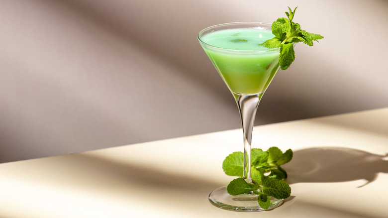 A grasshopper cocktail, with fresh mint as a garnish