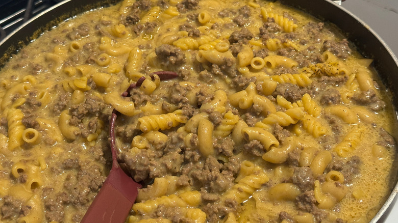 A pot of Hamburger Helper being cooked on a stove