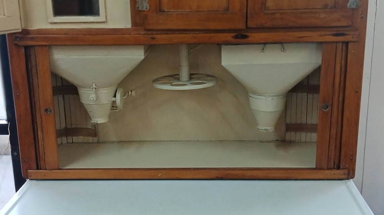 Close-up on built-in flour sifters in a Hoosier cabinet